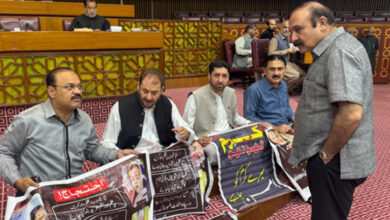 Hameed Hussain and other members of the National Assembly protest in front of the Speaker's desk against unrest in tribal districts