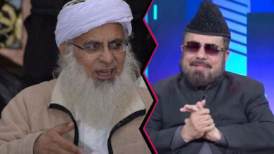 Burqa-clad Maulvi Abdul Aziz points a gun at the colorful Mufti Abdul Qavi